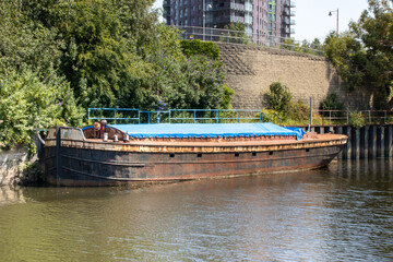 Photo of an old rusty barge located in the Canal in the Leeds City Centre