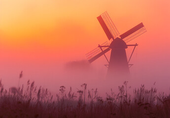 Windmill in foggy colorful sunrise. - obrazy, fototapety, plakaty