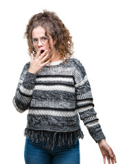 Beautiful brunette curly hair young girl wearing glasses over isolated background bored yawning...
