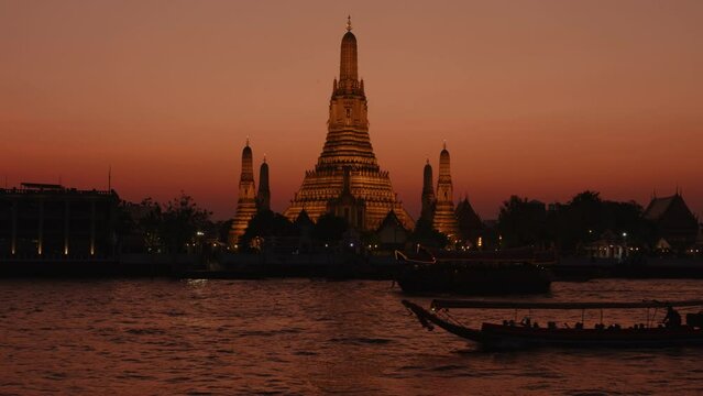 Night view of Wat Arun Ratchawararam on bank of Chao Phraya River Bangkok.