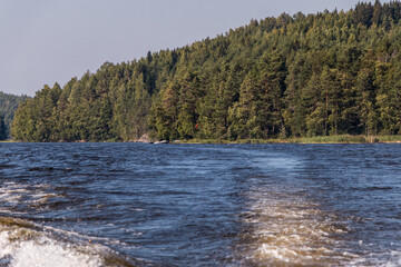view from a motor boat of the water of Lake Ladoga and rocky islands. Ladoga skerries. Beautiful landscape	