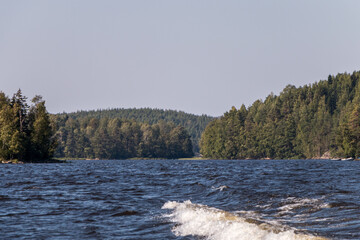 view from a motor boat of the water of Lake Ladoga and rocky islands. Ladoga skerries. Beautiful landscape	
