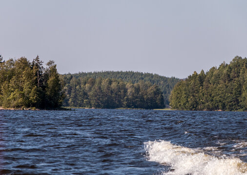 view from a motor boat of the water of Lake Ladoga and rocky islands. Ladoga skerries. Beautiful landscape	
