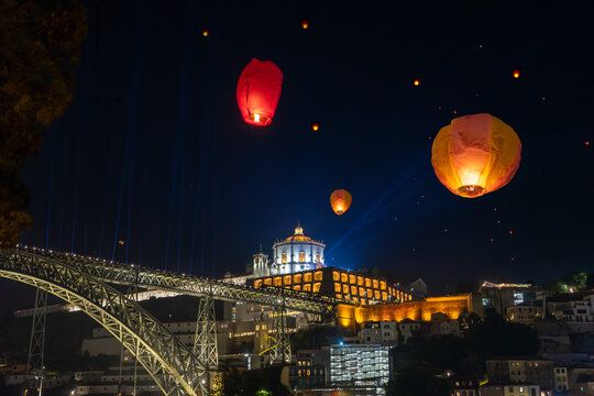 Festa de Sao Joao do Porto flying lanterns in Porto Portugal at st John's eve next to douro river bank Ponte Luis and Miradouro da Serra do Pilar