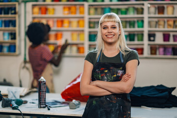 Fototapeta premium Confident print shop entrepreneur with arms folded smiling at the camera