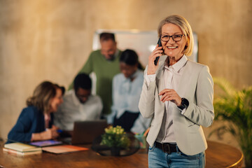 Executive having phone call at office on meeting of interracial team.