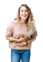 Beautiful young blonde woman wearing sweatershirt over isolated background Smiling and laughing hard out loud because funny crazy joke. Happy expression.