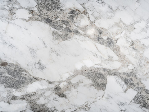 Texture of white granite slabs defines the background