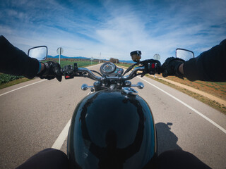 Black old motorbike travelling on a tarmac road driver point of view beautiful landscape