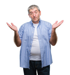 Handsome senior man over isolated background clueless and confused expression with arms and hands...