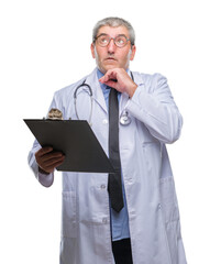 Handsome senior doctor man holding clipboard over isolated background serious face thinking about question, very confused idea