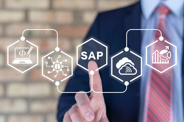 Business man using virtual touch screen presses abbreviation: SAP. SAP business process automation...