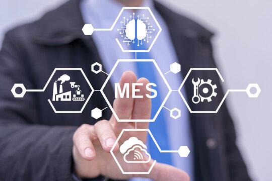 Business man using virtual touch screen presses abbreviation: MES. MES - Manufacturing Execution System concept. Manufacturing Execution System Automation Robotics Technology.