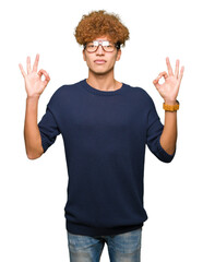 Young handsome man with afro wearing glasses relax and smiling with eyes closed doing meditation gesture with fingers. Yoga concept.