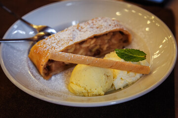 Traditional Austrian and Bavarian dessert - apple strudel with ice cream