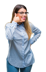 Young beautiful business woman wearing glasses over isolated background smiling doing phone gesture with hand and fingers like talking on the telephone. Communicating concepts.