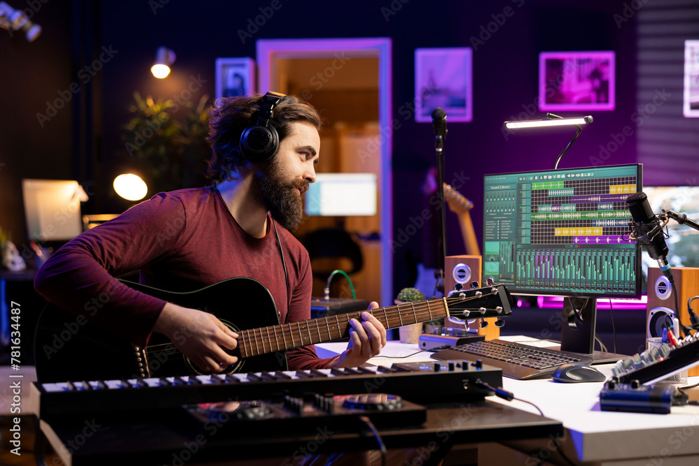 Poster Music engineer playing new tunes on acoustic guitar and recording with daw software interface, preparing to do mixing and mastering session. Young songwriter creating soundtracks with instrument.