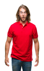 Fototapeta premium Young handsome man with long hair over isolated background afraid and shocked with surprise expression, fear and excited face.
