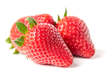 Fresh Ripe Strawberries Isolated on White. A vibrant cluster of fresh, red strawberries with green stems is prominently displayed against a clean white background, emphasizing their juicy freshness.