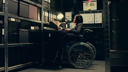 Wheelchair user conducting private investigation in disability friendly incident room, examining...