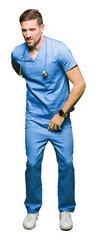 Handsome doctor man wearing medical uniform over isolated background Suffering of backache, touching back with hand, muscular pain