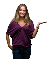 Fototapeta premium Young beautiful blonde elegant woman over isolated background smiling cheerful presenting and pointing with palm of hand looking at the camera.
