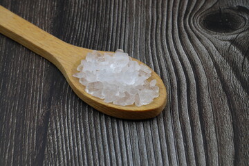 sea salt in a spoon isolated on black background