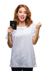Fototapeta premium Young beautiful woman holding passport of united states of america over isolated background screaming proud and celebrating victory and success very excited, cheering emotion