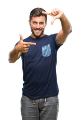 Young handsome man over isolated background smiling making frame with hands and fingers with happy face. Creativity and photography concept.