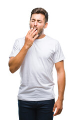 Young handsome man over isolated background bored yawning tired covering mouth with hand. Restless...