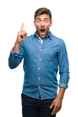 Fototapeta premium Young handsome man over isolated background pointing finger up with successful idea. Exited and happy. Number one.