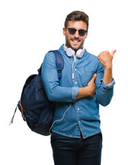 Young handsome tourist man wearing headphones and backpack over isolated background smiling with...