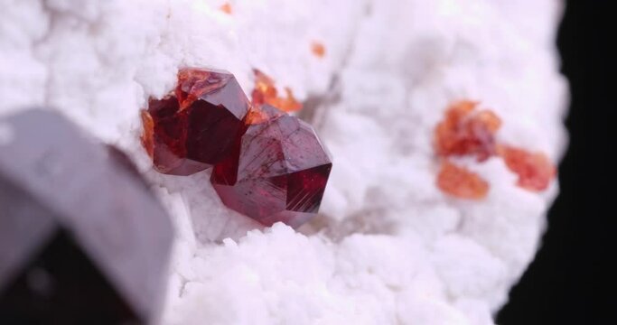 red Spessartine garnet on orthoclase matrix. Specimen from Tongbei, China. macro photography detail texture background. close-up raw rough unpolished semi-precious gemstone