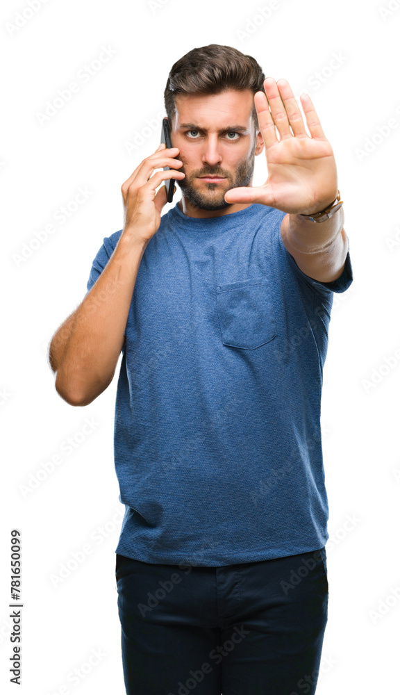 Wall mural Young handsome man talking on smartphone over isolated background with open hand doing stop sign with serious and confident expression, defense gesture