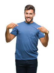 Young handsome man over isolated background looking confident with smile on face, pointing oneself...