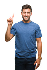 Young handsome man over isolated background showing and pointing up with finger number one while...