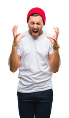 Naklejka premium Young handsome man over isolated background celebrating mad and crazy for success with arms raised and closed eyes screaming excited. Winner concept