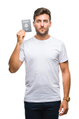 Young handsome man holding passport of united states over isolated background with a confident...