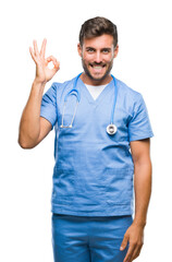 Young handsome doctor surgeon man over isolated background smiling positive doing ok sign with hand...