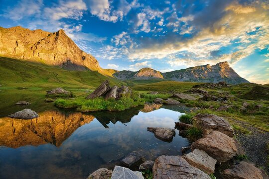 Reflection of the mountains and clouds in the Blausee at sunrise, Melchsee-Frutt, Canton Obwalden, Switzerland, Europe
