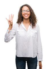 Beautiful young hispanic woman showing and pointing up with fingers number four while smiling confident and happy.