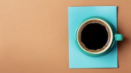 A cup of coffee on blue paper on brown surface