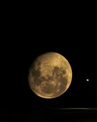 Obraz premium Doble exposición de la luna junto a una farola en la ruta.