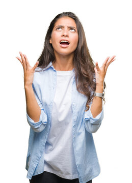 Young beautiful arab woman over isolated background crazy and mad shouting and yelling with aggressive expression and arms raised. Frustration concept.