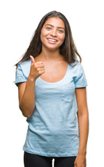 Fototapeta premium Young beautiful arab woman over isolated background doing happy thumbs up gesture with hand. Approving expression looking at the camera with showing success.
