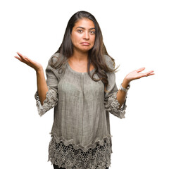 Young beautiful arab woman over isolated background clueless and confused expression with arms and...