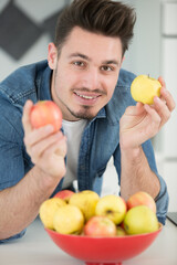 happy young man takes apples