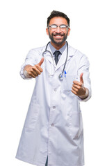 Adult hispanic doctor man over isolated background approving doing positive gesture with hand, thumbs up smiling and happy for success. Looking at the camera, winner gesture.