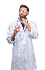 Adult hispanic doctor man drinking glass of water over isolated background serious face thinking about question, very confused idea