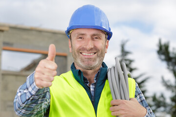 happy male builder showing thumb up - obrazy, fototapety, plakaty
